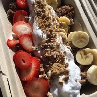 French toast topped with banana cream, coconut whipped cream, fruit & date sunflower butter crumble. Organic & Gluten-free  at Greens Please Wellness Kitchen in Poway