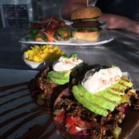 Tacos with burger in the background at Vibe Cafe in Phnom Penh