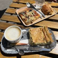 pizza, pain au chocolat, cappuccino and quiche  at VG Pâtisserie in Paris