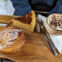 Cinnamon roll (bottom), Flan (top left), Cappuccino with oat milk (right) at VG Pâtisserie in Paris