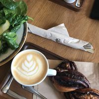 Lattes, cinnamon roll, chocolate twist, and salad  at La Colectiva Cafe in Madrid