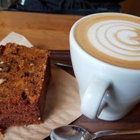 Carrot cake and latte at La Colectiva Cafe in Madrid