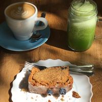 Delicious lemon blueberry cake, green juice and oat latte at La Colectiva Cafe in Madrid
