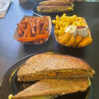 Front: Cheese and chorizo toastie
Middle: Sweet potato fries & Nuggets with French fries
Back: Cheese, Ham, Chorizo, back toastie at Vegana By Tentúgal in Porto