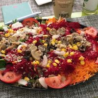 Huge salad with carrots, mushrooms, beets, corn, olives, mixed greens; onions, cucumbers and tomatoes  at Vegana By Tentúgal in Porto