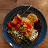 Lebanese Mezze Plate: Bulgur tabbouleh, tofu shakshuka, onion stuffed with muhammara, vegetable spiedini in tahini and roasted vegetables in dukkah. at Simone's Kitchen in Antwerpen