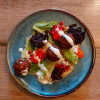 Falafel trio: Crisp herbed chickpea fritters with smoked babaganoush, garlic-lemon yogurt, red onion jam and a raw romansesco-tomato salad. at Simone's Kitchen in Antwerpen