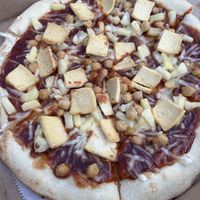 Bbq sauce base, vegan cheese, chickpeas, pineapple, and tofu  at Nags Head Pizza Company in Nags Head