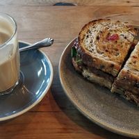 Coffee & toasted tempeh, satay, kraut sandwich at Friends of the Earth Cafe in Collingwood