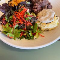 large salad bowl with: tofu millet croquette,  salad, broccoli with satay and black bean sweet potato stew  at Friends of the Earth Cafe in Collingwood