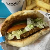 Cezar burger with EPOCH patty and peach juice  at Epoch Vegan Burger in Budapest