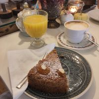 Fresh-pressed orange juice, flat white, vegan cake at Cafe im Süden in Bad Toelz