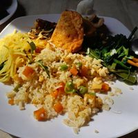 Plate with everything on it. Spice noodles, 3 types of tofu, morning glory, fried rice and vegan sausage. Said to be 15k, was 40k at Am Thuc Chay in Hue