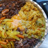 medium with 2 proteins (curry chickn, Brown stew) and 3 sides (rice and peas, cabbage, 9 bean stew) and homemade hot sauce  at Ninth Square Market Caribbean Style in New Haven