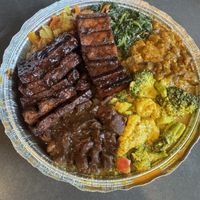 Jerk tofu, brown stew chunks, cabbage, curry mixed vegetables, sautéed greens, and stewed eggplant  at Ninth Square Market Caribbean Style in New Haven