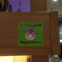 Happy Cow sticker outside of restaurant at Minami Aoyama Yasai Kichi in Yokohama