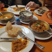 Chola Bhatura with naan bread on the right. Lentils curry and rice on the left at Buena Vista Curry Club in Havana