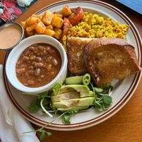 Breakfast plate with beans, scrambled tofu, toast, seasoned potatoes avocado and salad  at Springhouse in Halifax