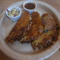Birria: 3 corn tacos dipped & fried. Filled with ch*cken & mushroom, cheesy nacho sauce, onion & Jalapeño. Served with a pineapple salsa and Chipotle dip at GRUB in Manchester
