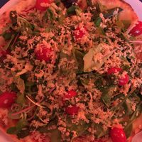 Tomato, rocket salad, pesto, and vegan Parmesan cheese pizza at Mastino V in Amsterdam