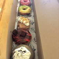 (Top to bottom) guava pineapple fritter, doe, sour yuzu + green tea, banana cream pie, chocolate raspberry cream pie, Portland fog  at Doe Donuts in Portland