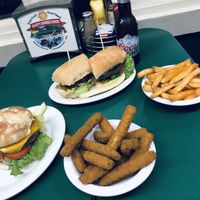 Impossible and portobello burger with a side of zucchini fritters and red fries   at Happy Burger Diner in Mariposa