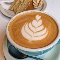 Oat latte and vegan biscoff cake at Academy in Winchester