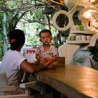 Mom and kid at a table inside of 9 Angels Warung at 9 Angels Warung in Ubud