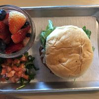 Vegan Farmhand Kchn burger with a side of fruit at FarmHand Kchn in St Augustine