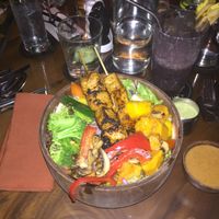 Dragon bowl with tofu skewers and purple “extreme green smoothie” (spirulina, dates, coconut water, banana, blueberries) at Kismet Restaurant & Lounge in Ubud