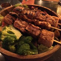 Dragon bowl with tofu, tempeh and vegan chicken skewers.  at Kismet Restaurant & Lounge in Ubud