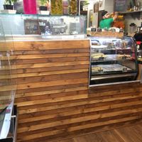 Inside Falafel Xpress, interior, fridge section and view into the open-plan kitchen area. at Falafel Xpress in Chester