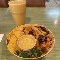 Mango zinger smoothie and gogi tacos with a side of chips and the best queso I’ve had    at Juice Pharm in Duluth