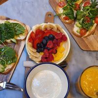 Avocado toast with vegan cheese, granola anf fruit bowl with vegan yogurt at Strata Bakery in Barcelona