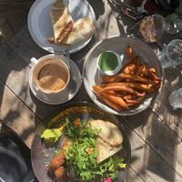 Vegan falafel wrap from the display, a tasting platter veganized, sweet potato chips and coffee. at Garden Grub Cafe in Wingham