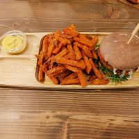 Squash Burger with sweetpotatoe fries and spicy vegan cheese dip  at Tökmag Vegan Street Food in Budapest