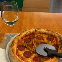 Pepperoni pizza that’s completely vegan. I paired it with the sweet white wine!  at Pizzi & Dixie in Madrid