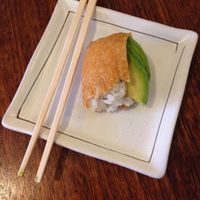 Vegan inari (i.e. Bean curd) pockets with seasoned rice, sesame & avocado. Another version with seasoned seaweed on top instead of avocado is available too.  at Ten Koo in Armidale
