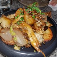 Roasted potatoes, wild mushrooms and onion over garlic confit at Bana in Tel Aviv