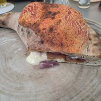 Calzone veg with vegan mozzarella, vegan gorgonzola, vegan salame and red onions. at Birra & Farina in Castelletto Sopra Ticino