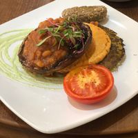 Vegan plant based brunch! With mushroom, pea and spinach fritter topped with hummus and house baked beans with a nut/seed sausage  at Vinnie's Eatery in Cheltenham