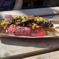 Vegan pink hot dog. Topped with mushrooms, avocado, beans and crispy onions. The bun is a beautiful pink from natural beetroot dye. The dog itself was delicious 😋  at Pom Kitchen - Sharrow in Sheffield