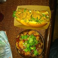 Vegan "hot dog" and cauliflower wings with their homemade sauce at Jah Jah in Paris