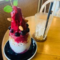 Chia pudding with berry sorbet and a empty Glas of caramel latte at Beach Bowl in Legian