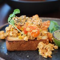 Korean Kimchi Tofu Scramble with toasted sesame seeds, charred lime. at Cafe Diversity in Moreton Bay Region
