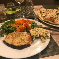 Eggplant parmigiana, pizza in background  at Nirvana in Florence