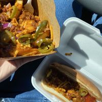 Chili cheese fries with vegan cheese, red onion, and jalapeños & vegan hot dog.  at Earle's on Crenshaw in Los Angeles