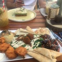 The ‘kasplater’. Hummus, kasballs, mushroom calamari, cauliflower, quinoa, peanut sauce, spinach, cashew cream and pita! Amazing. In the background a raw lasagne.   at The Kasbar in 