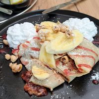 Spelt pancake with bananas, chocolate, toasted hazelnuts and a berry sauce at Natureza in Prague