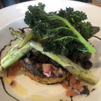 Spring Special (vegan) Sweet potato hash brown, eggplant, black beans, tomato salsa, asparagus, balsamic reduction and crispy kale. Delicious.  at Reflections Restaurant in Lake Tekapo
